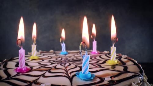 Festive Birthday Cake with Bright Burning Candles