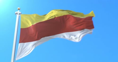 South Ossetia Flag Waving in Wind Against Clear Blue Sky