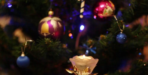 Decorated Christmas Tree with Ornaments and Candle