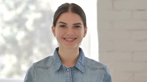 Young Woman Smiling Brightly at Camera