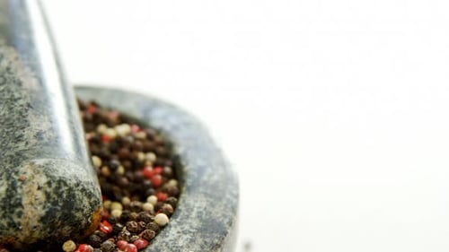 Colorful Peppercorns in Mortar and Pestle Close Up