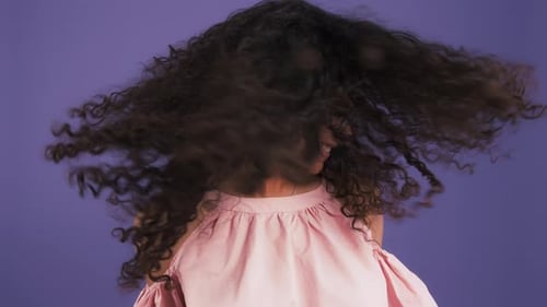 Woman with Curly Hair Shakes Head Vigorously