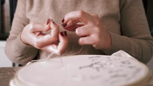 Woman Prepares Thread for Embroidery Close Up
