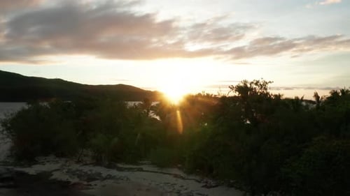The Stunning Scenery Of A Peaceful Calm Sea With Green Trees During Sunrise in Fiji - Aerial Shot