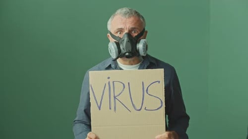 Man in Mask Holds Virus Sign
