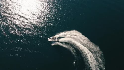 Birds Eye View Of Speed Boat Turns With White Water Spray