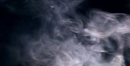 Ethereal White Smoke Drifting Against Dark Background