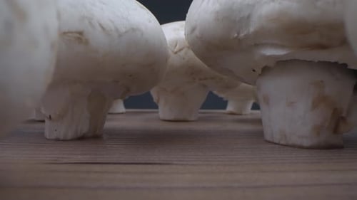White Button Mushrooms on Brown Wood Surface