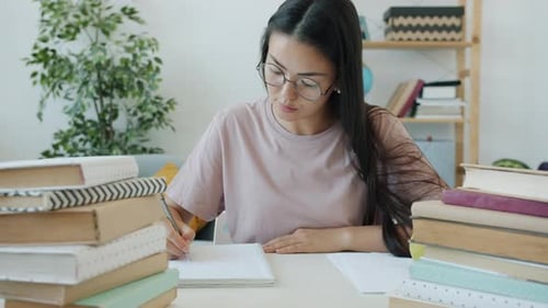 Woman Studying with Books at Table