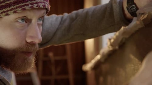 Bearded Artist Crafting Plaster On Construction Site