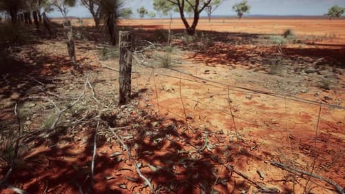 Animated Rural Fence Line Appearing in Arid Landscape