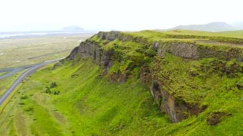 4K Aerial Drone Footage Of Beautiful Large Mountain Top Covered In Bright Green Grass With Birds
