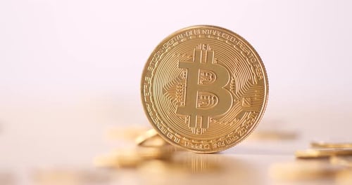 Golden Bitcoin Cryptocurrency Coin with Falling Coins