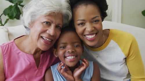 Portrait of happy african american grandmother with adult daughter and granddaughter