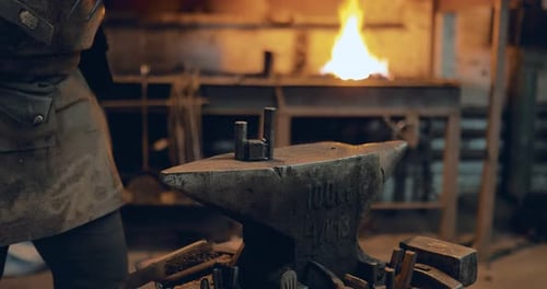 Blacksmith Forging Metal on Anvil with Hammer