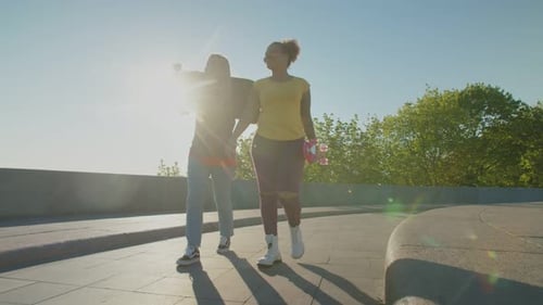Friends Strolling With Skateboard and Roller Skates