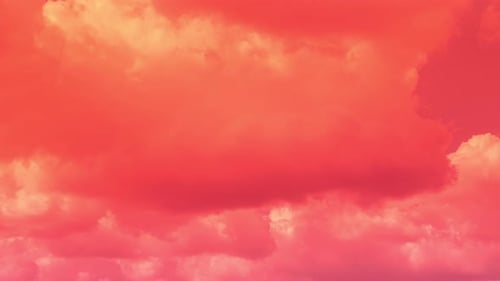 Pastel Clouds Drift in a Pink Sky