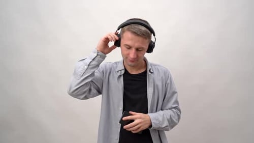Young Adult Listening To Music With Headphones