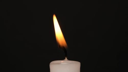 Candle Flame Flickering in Dark Room