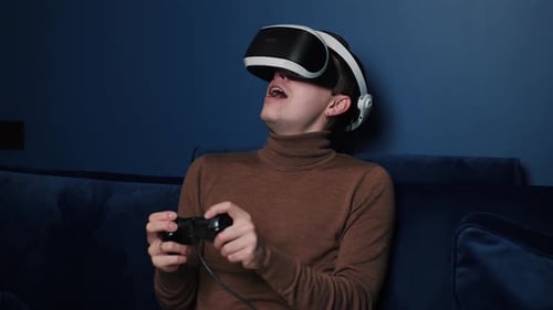 Man Playing VR Game With Headset And Controller