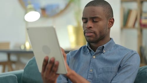 Man Using Tablet Technology at Home