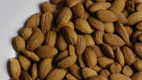 Cinematic, rotating shot of almonds on a white surface - ALMONDS 018