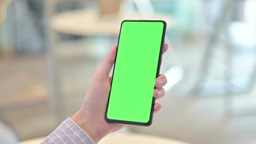Rear View of Female Hand Holding Smartphone with Chroma Screen