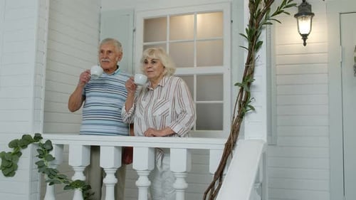 Elderly Couple Enjoying Coffee on the Porch