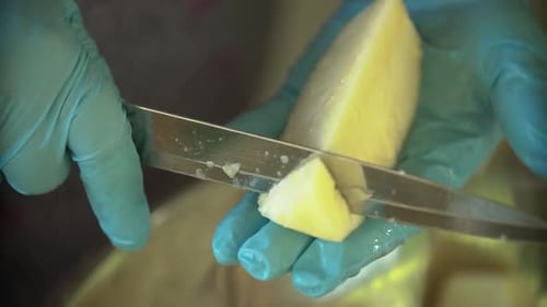 Cutting Chunks of Yellow Pineapple with Knife