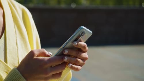 Woman Typing on Cell Phone Device Close Up