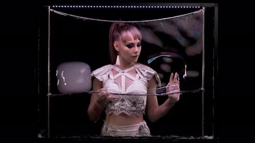 Woman Performing with Soap Bubbles in Dark Studio