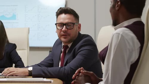 Businesspeople Talking at Corporate Conference Room Meeting