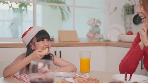 Festive Family Meal with Santa Hats in Home