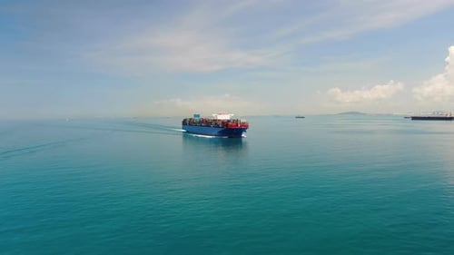 A large container ship for transporting goods near the port of Singapore.