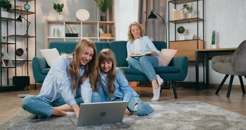Family Using Laptop Together in Bright Living Room