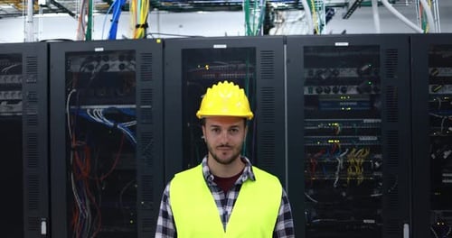 Young Technician Standing in a Server Room