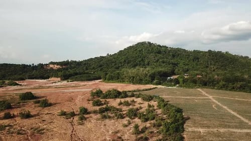 Aerial View of Farmland With Green Hill