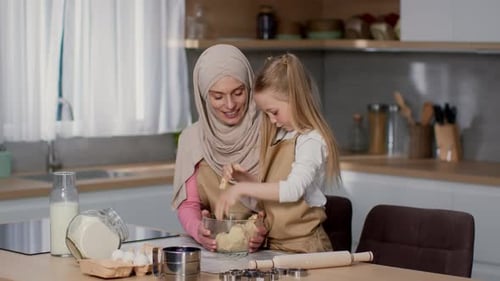 Mother and Daughter Baking Together in Kitchen
