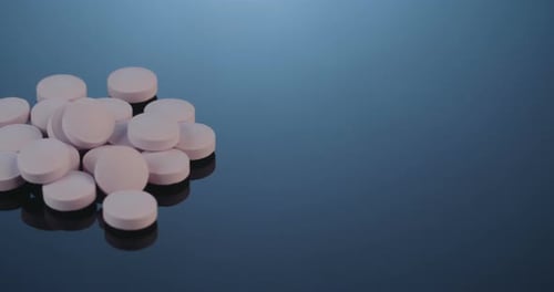 Accumulation of White Pills on a Reflective Surface