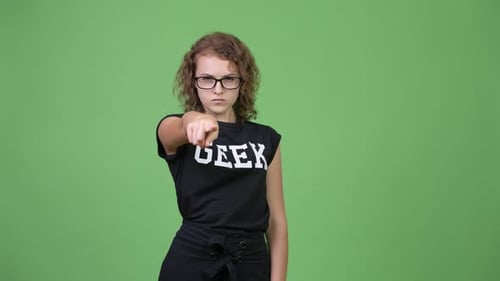 Girl Pointing Confidently in Studio Setting