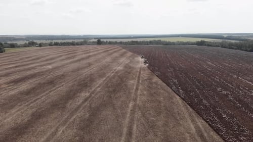 Tractors Tilling Soil on Farmland Aerial View