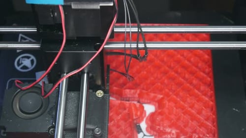 3D Printer Manufacturing Red and White Object