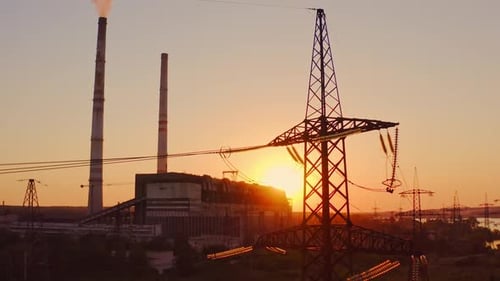 Industrial high voltage electricity tower. Silhouette of high voltage electric tower on sunset time.