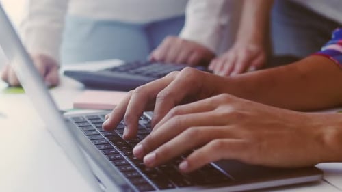 Male hands of black man typing on laptop keyboard, close-up. Fingers on the keyboard of a modern lap