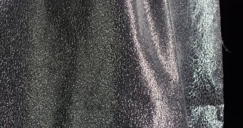 Reflective Silver Fabric Flowing Downward