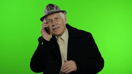 Senior Man Energetically Talking on a Cell Phone