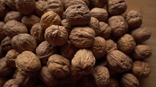 Pile of Walnuts on Wooden Surface