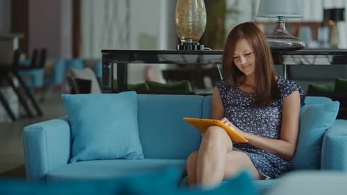 Woman Using Tablet Pc in Hotel Lobby