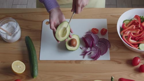Cutting Avocado for Fresh Salad Preparation