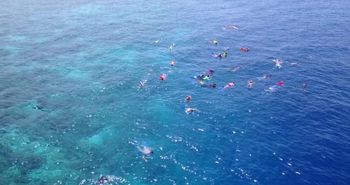 Daytime birds eye island view of a white paradise beach and aqua blue water background in hi res
